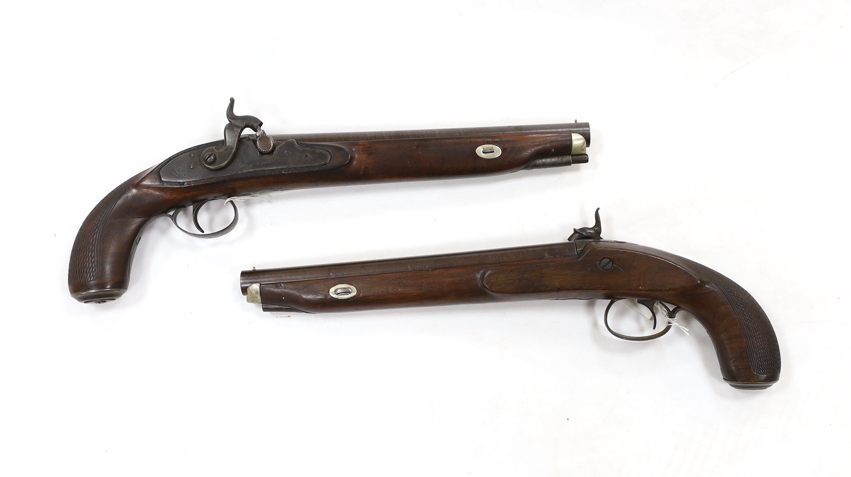 A pair of 12 bore percussion pistols converted from percussion sporting guns, round twist barrels, locks stamped G. Day, iron mounts with nickel fore-end caps and chequered grips